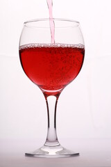 red wine pouring into glass