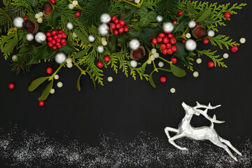 Christmas background border with silver reindeer and glitter path, holly, traditional winter...