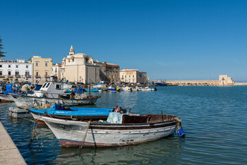 Traditional wooden fishing boats in the harbor of Trani in Southern Italy 