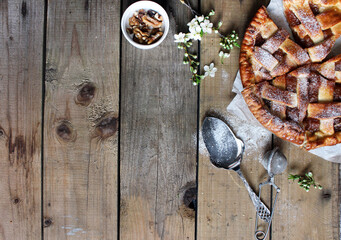 Homemade Apple Pies on rustic background, top view, copy space. Classic autumn Thanksgiving pastry dessert - organic apple pie.