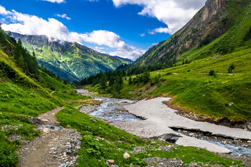 Fototapeta na wymiar Valley With Alpine River To Mountain Peak Grossglockner In Kals In Austria