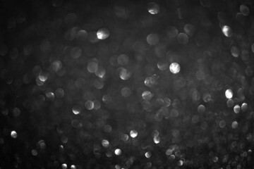 Black bokeh background. Vintage glitter lights, glowing christmas effects backdrop photo