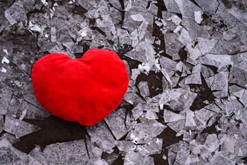 Obraz premium A red heart in shards of ice. Unrequited love, infidelity