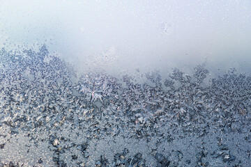 the icy pattern on the window is like a misty landscape - twilight background
