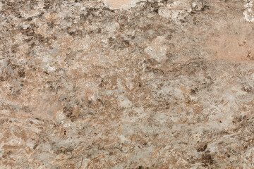 Natural stone texture. Closeup of layered rough grainy rock surface. Flat lay, top view. Different shades of brown. Copy space. 