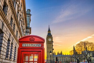 Obraz na płótnie Canvas Big Ben with red telephone booth at sunrise in London. England