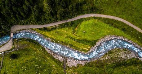 Drone Aerial View Of Clear Mountain River And Forest Road In Deferegental In Tirol In Austria