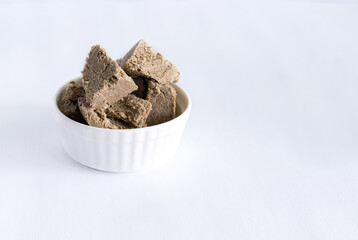 halva from sunflower seeds on a white plate. national traditional sweetness of turkish halva on the table. High quality photo