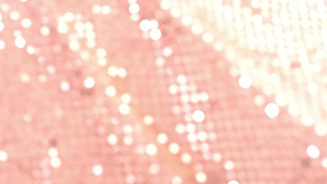 pink texture of sparkling sequins on light fabric, background colored blur bokeh, round, defocused abstract christmas, wedding wallpaper, basis for designer
