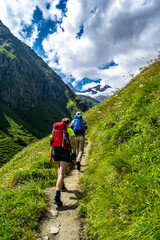 Hiking Group In Valley Of Umbalfaelle On Grossvenediger With View To Mountain Roetspitze In Nationalpark Hohe Tauern In Tirol In Austria