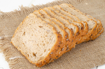 Sliced whole grain bread with sunflower seeds, square shape. Studio Photo