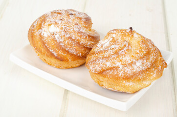 Fresh homemade cakes with cream and powdered sugar. Studio Photo