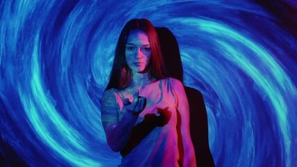 Mind control. Hypnosis therapy. Telepathy influence. Mysterious neon light woman beckoning inviting to follow with finger gesture in pink on blue glowing spiral background.