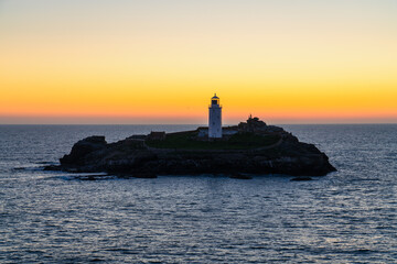 Godrevy lighthouse at sunset in Cornwall. United Kingdom