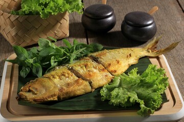 Cut Raw Bandeng Presto Juwana, Milkfish Cooked with Pressure Cooker, Served with Chilli Paste (Sambal) and Fresh Vegetable. Before Frying