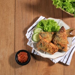 Bandeng Presto Juwana, Milkfish Cooked with Pressure Cooker, Served with Chilli Paste (Sambal) and Fresh Vegetable