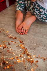 baby's feet with christmas decorations