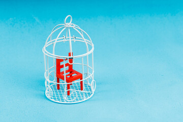 red plastic chair in the bird cage. toy items