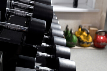 Obraz premium rows of dumbbells for strength training, storage of sports equipment