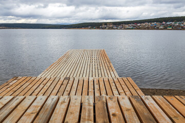 Fototapeta premium stepped pier over the pond, wooden pier