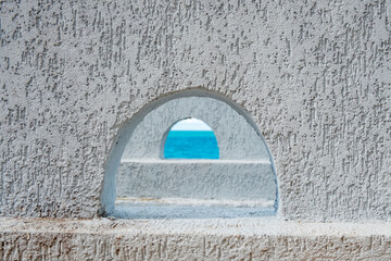 sea view through semicircular openings in the wall, through two at once