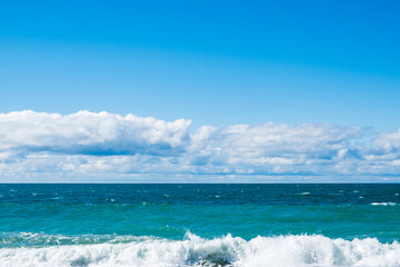 light blue sea and blue sky. waves on the sea in daylight