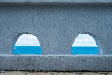 view of the sea horizon through semicircular windows that look like eyes
