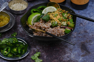 Vegan gluten free buckwheat groats with sauteed okra, sliced jalapenos in black bowl