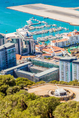 Fototapeta premium Gibraltar city and bay panoramic view from the Rock of Gibraltar with downtown, airfield and artillery battery in the foreground