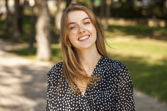 Portrait of a teenage girl on the background of a city park