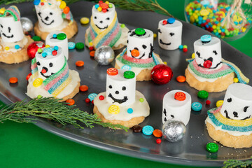 Fototapeta na wymiar Melting marshmallow snowmen preparation process. Christmas, New Year kid's sweet