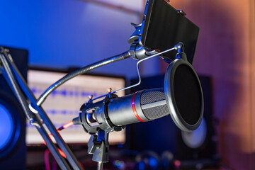 Pop filter microphone records audio during a podcast. Sound recording studio