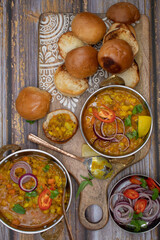 Vegetarian indian pav bhaji board: mixed potato and vegetables curry with butter toasted bund and side dishes
