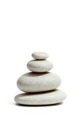 Obraz na płótnie Canvas Zen stones pyramid isolated on white background. Vertical photo