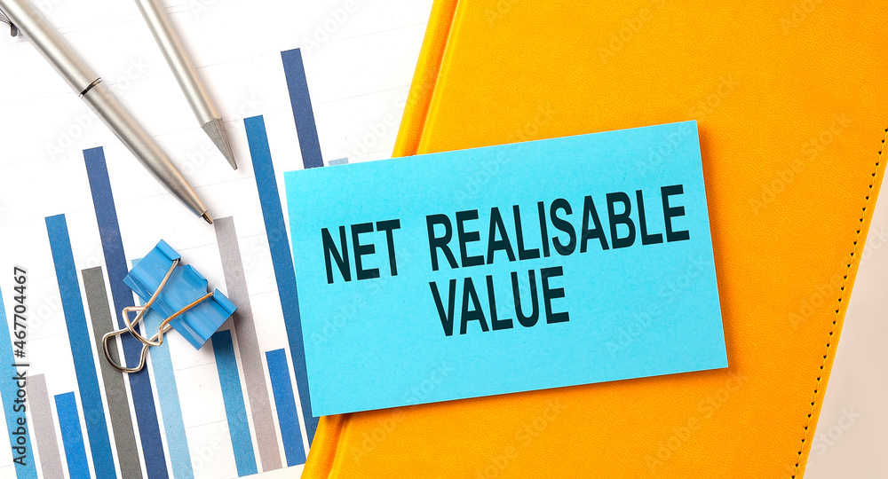 Aufkleber net realisable value text on sticker on yellow notebook with chart and pen