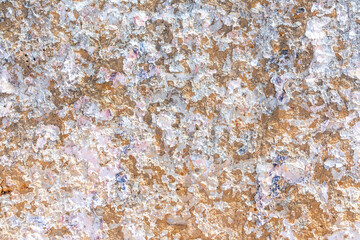 background of old plaster wall with peeling colors in white and orange