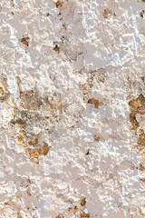 background of old plaster wall with peeling colors in white and orange