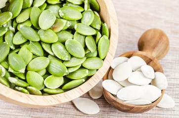 Pumpkin seeds green and unpeeled in bowl.