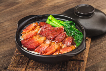 Cantonese style cooking of claypot rice with waxed meats