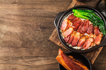 Cantonese style cooking of claypot rice with waxed meats