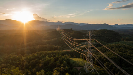 aerial view of a large high voltage light pole international power transmission On a warm day, at...