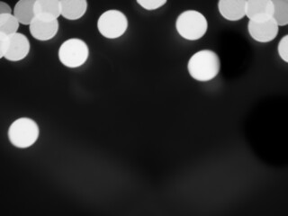 Gray bokeh background. happy new year 2022. black and white abstract effect light night out of focus circle wallpaper. for christmas party celebration holidays or broken heart background concept.