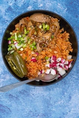 Korean kimchi rice with pickled eggs, topped with chopped fresh vegetables