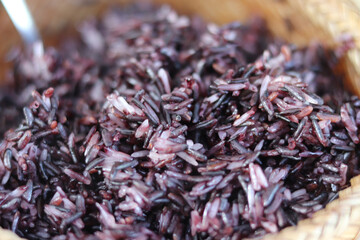 Wooden bamboo traditional style box with  black sticky rices on blurred,Portrait,Asian style.
