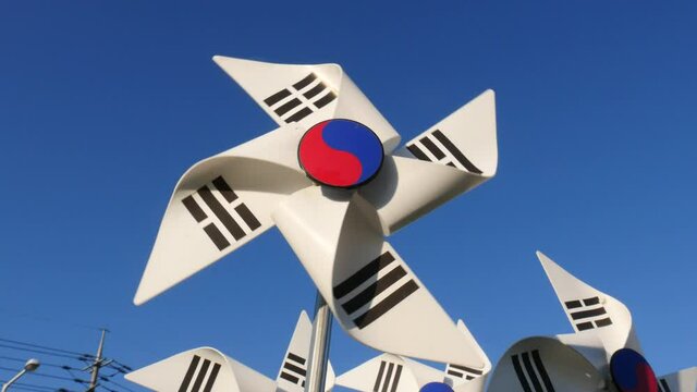 Korean Flag pinwheel toy in the wind blue sky background Taegeukgi.