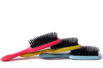 Multi-colored hair combs on an isolated white background. 