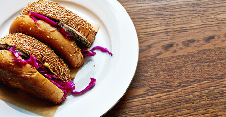 Healthy Burger with roast beef and coleslaw salad on white plate with copy space. wide banner.