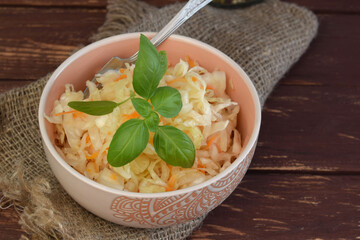 Sauerkraut in a plate. Homemade sauerkraut with carrots. Fermented food. A natural probiotic.