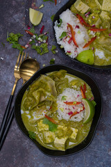 Vegan thai green curry with tofu and dumplings served with rice