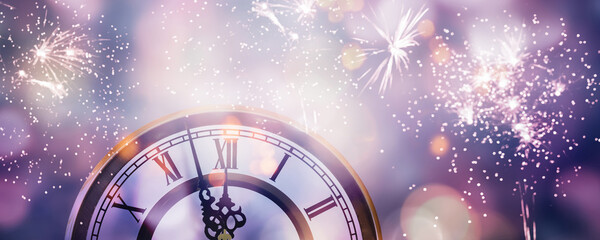 blurred firworks around a midnight countdown clock with roman numbers, abstract nigh sky with...